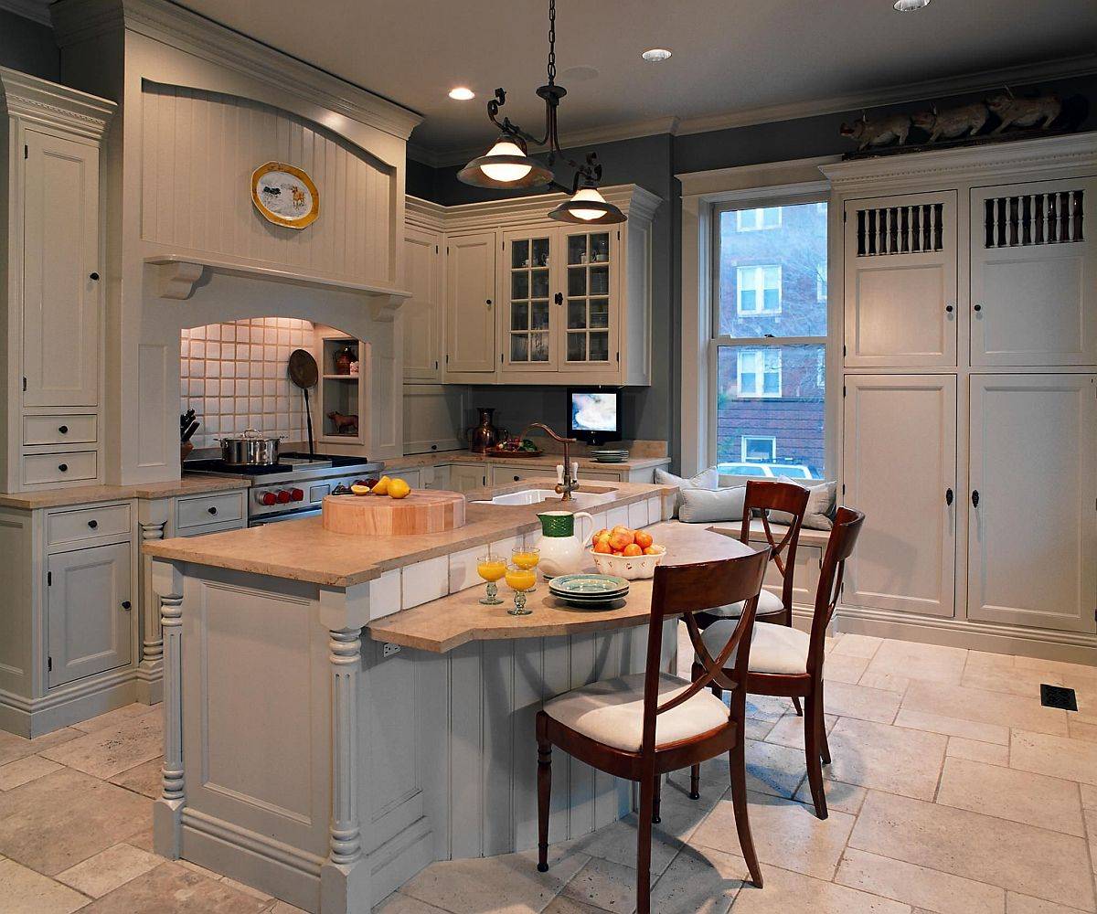 Wooden breakfast bar sits at a level lower than the lovely kitchen counter