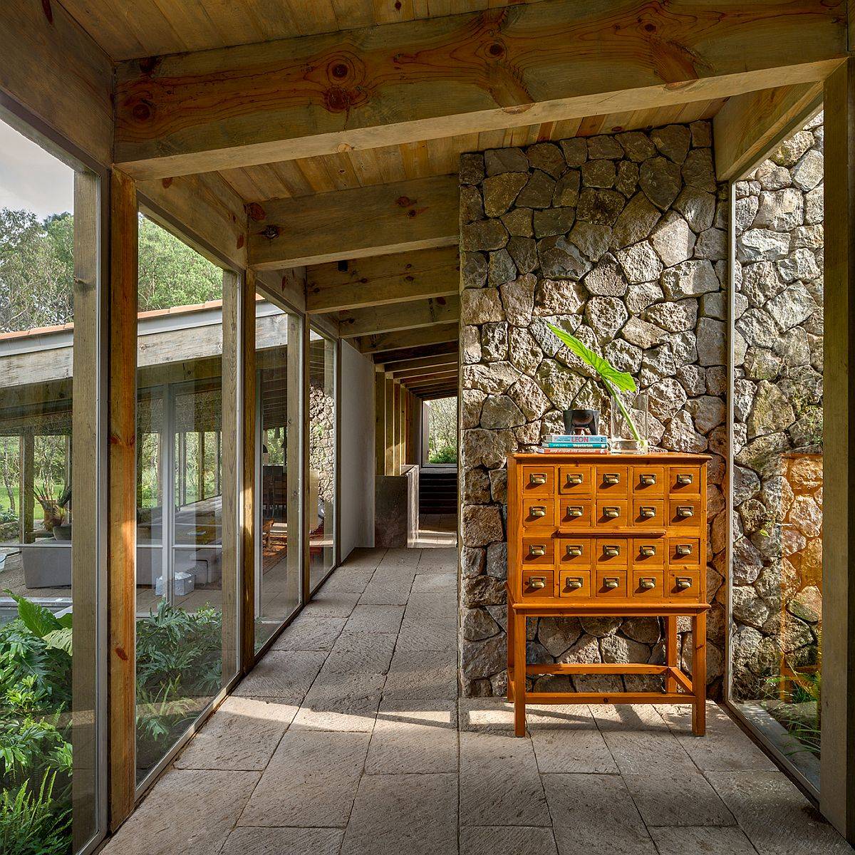 Wooden ceiling along with stone walls and glass floor-to-ceiling walls usher in a whole world of textures