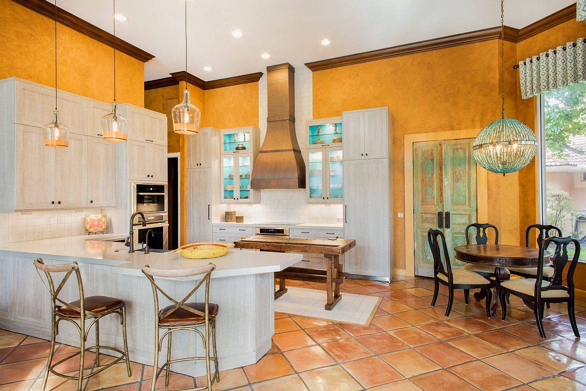 Custom textured walls in orange make the biggest visual impact in this spacious mdoern kitchen