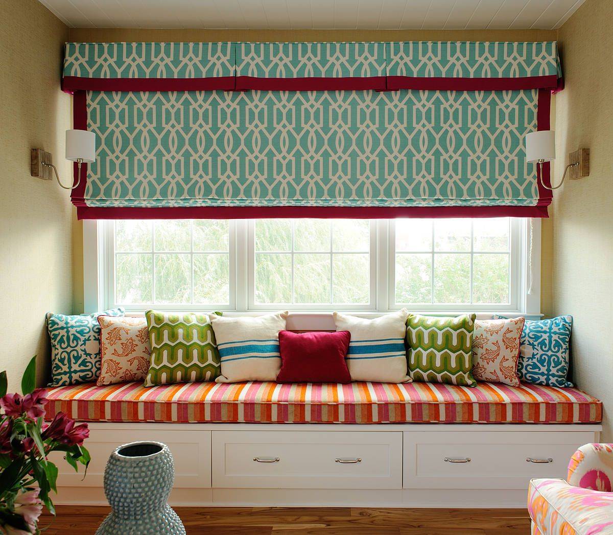 Delightful window seat in the family room brings colorful personality to the space