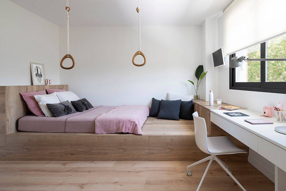 Elevated wooden platform in the bedroom gives the space a casual elegant appeal