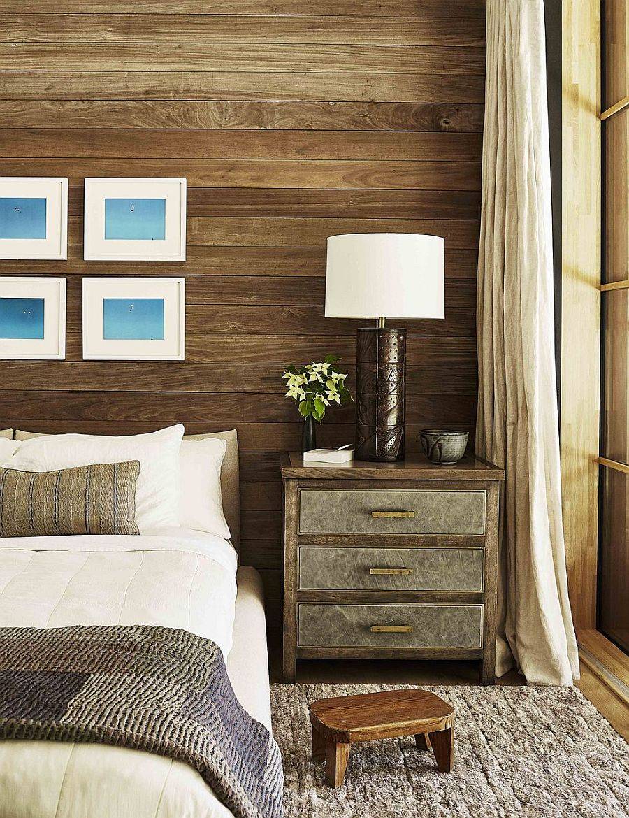 Muted colors, wooden walls and plush textures give this bedroom that perfect and cozy fall vibe