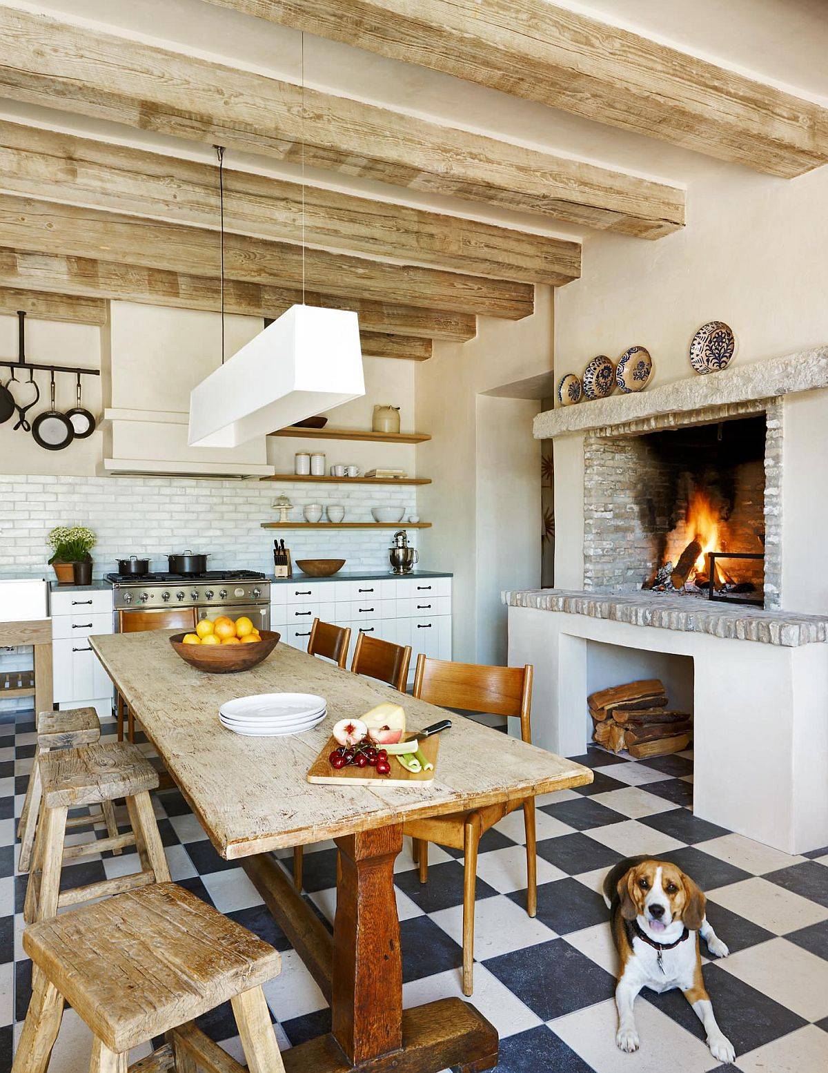 Rustic eat-in kitchen with Mediterranean touches, exposed ceiling beams and a fireplace
