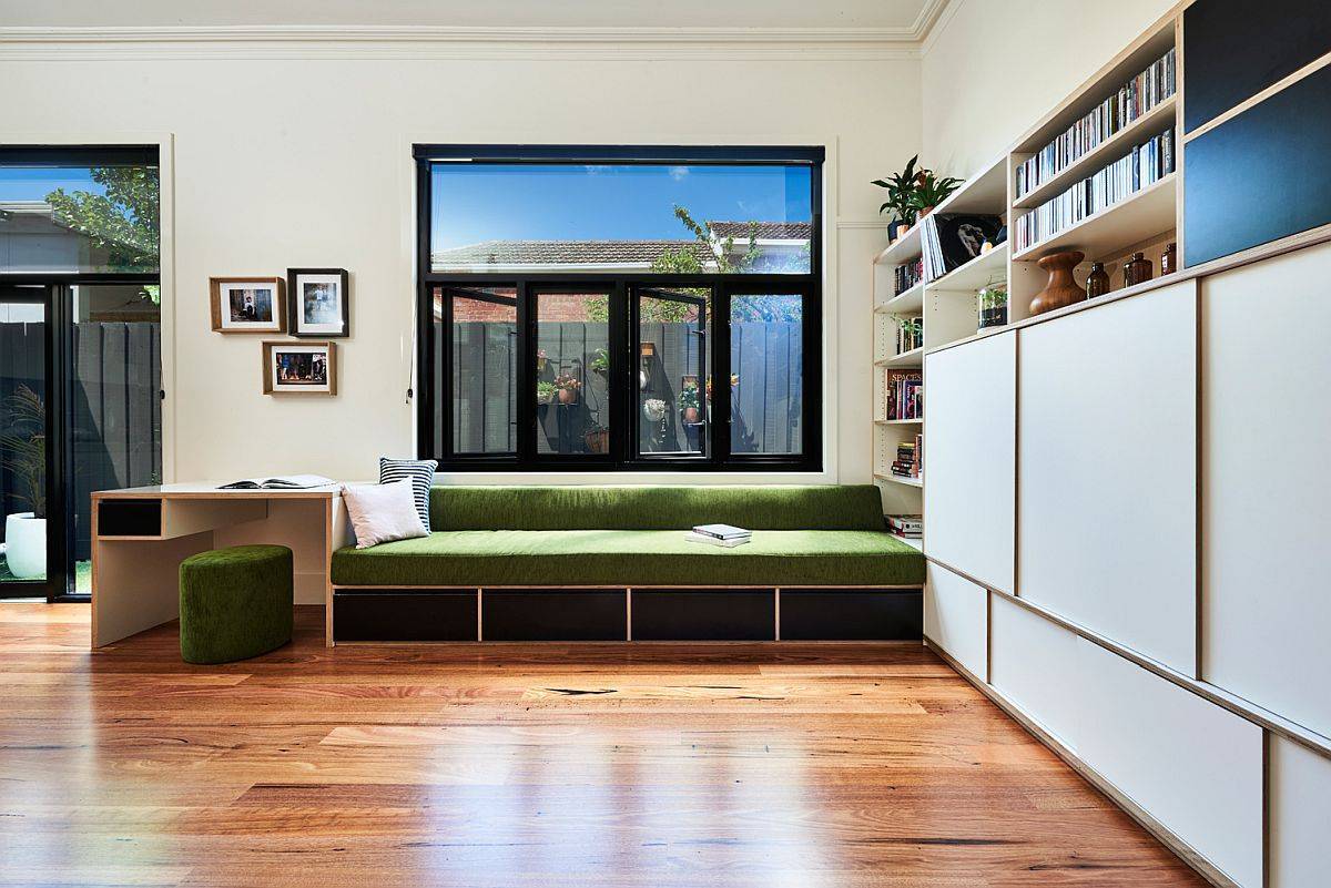 Same wooden feature in the family room morphs into both the built-in bench and work desk in here