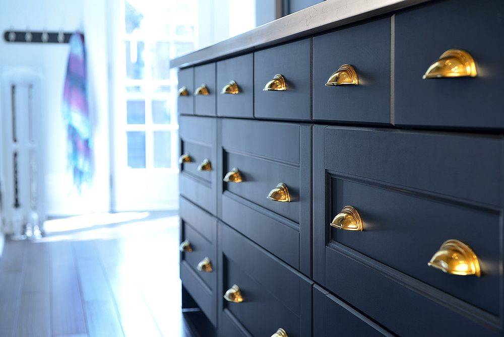 The sight of brushed antique English brass pulls makes a difference in this blue and white kitchen