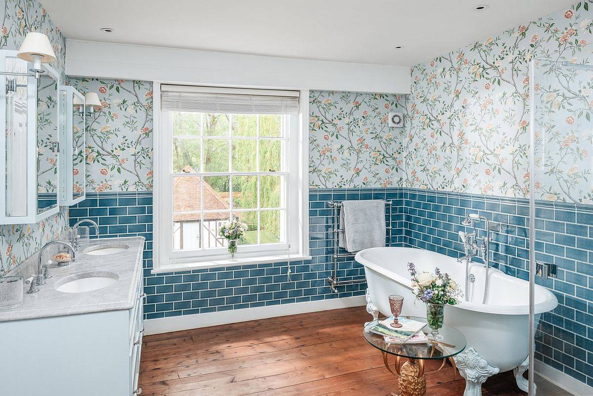 Vivacious bathroom with wallpapered backdrop, wooden floor and marble countertops