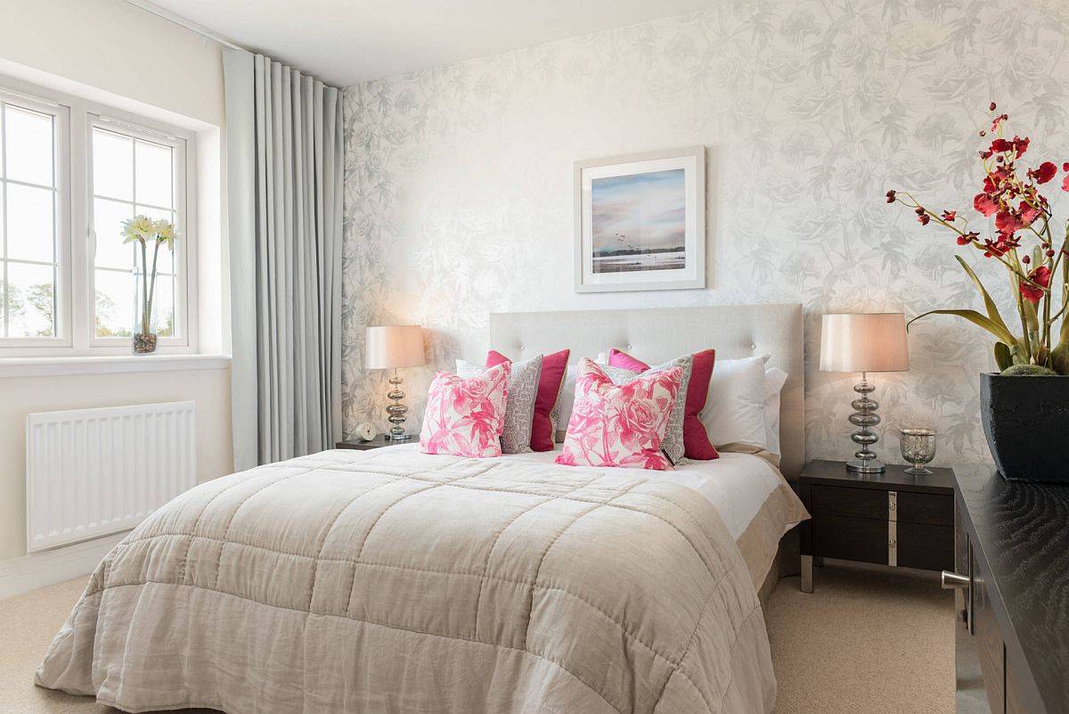 Wallpaper, accent pillows and the decorative vase with flowers adds natural motifs to this classy bedroom