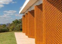 Custom-pivoting-wooden-panels-with-perforated-design-give-the-home-a-unique-identity-29553-217x155
