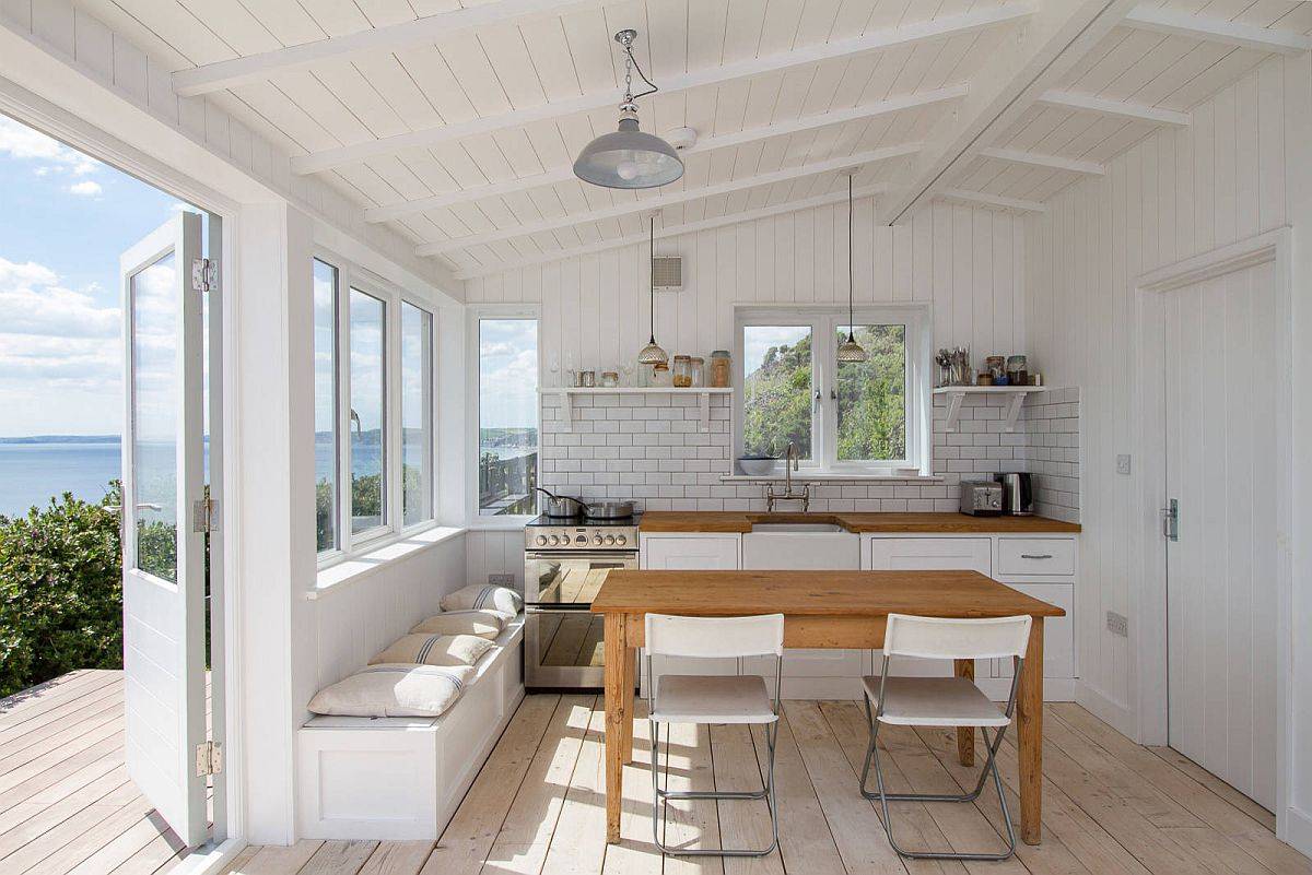 Light and breezy beach style one-wall kitchen in white with views to admire