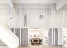 Metallic-mesh-frames-delineate-the-public-areas-from-the-office-space-94512-217x155