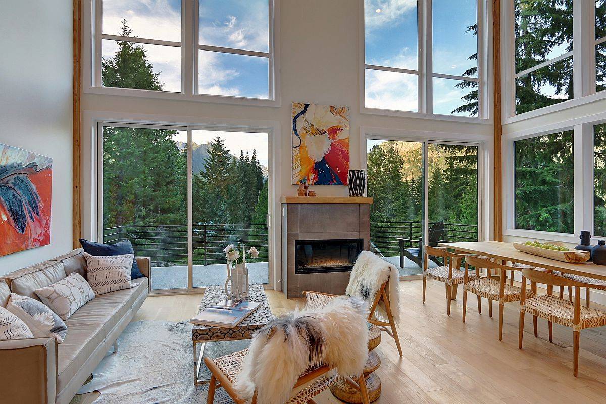 Stunning natural views outside steal the spotlight in this amazing living room with a high ceiling