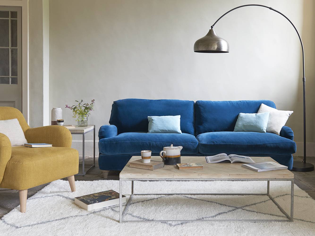 Casual and relaxed living room with blue velvet sofa (from Loaf)