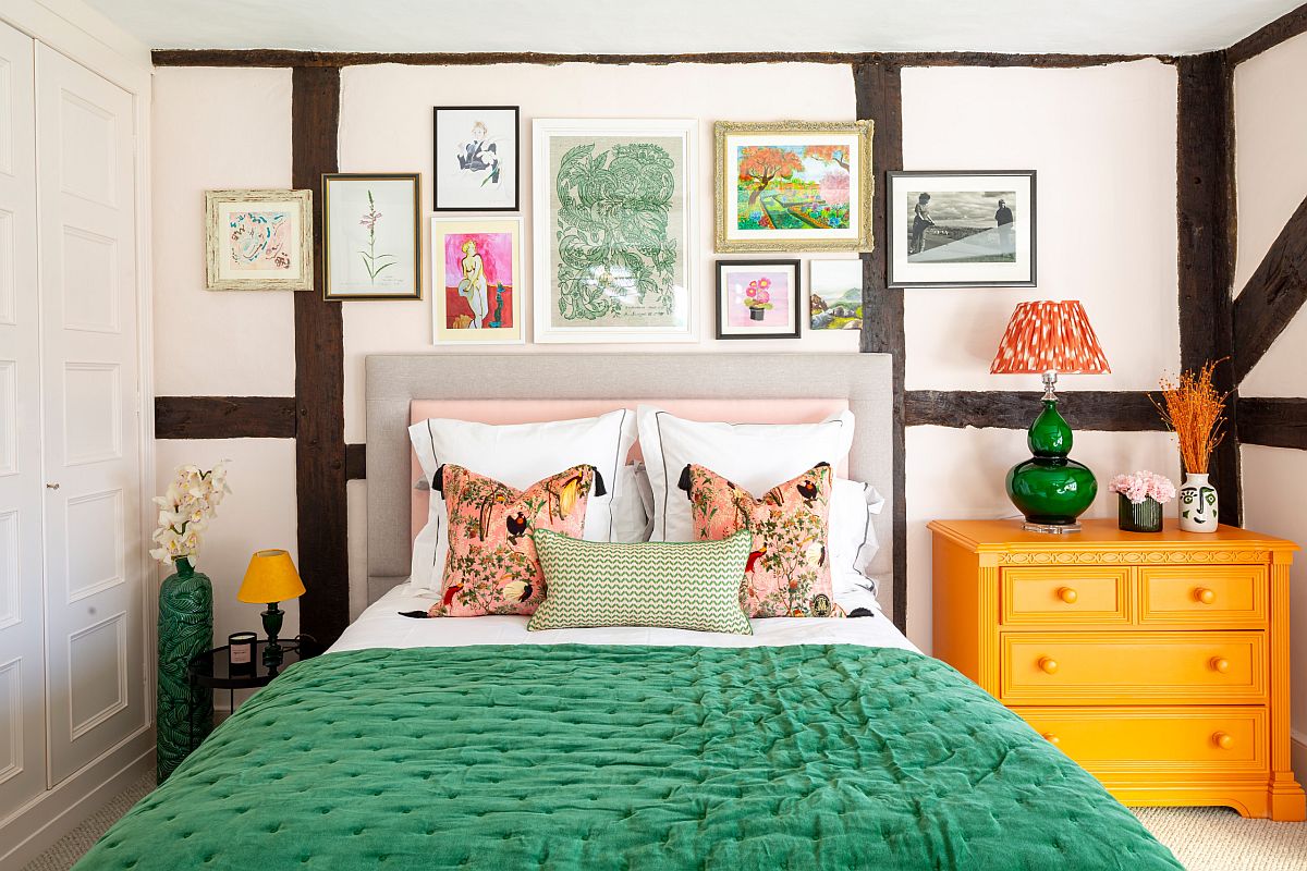 Bedding and nightstands add green and yellow accents to an eclectic bedroom with a small gallery wall