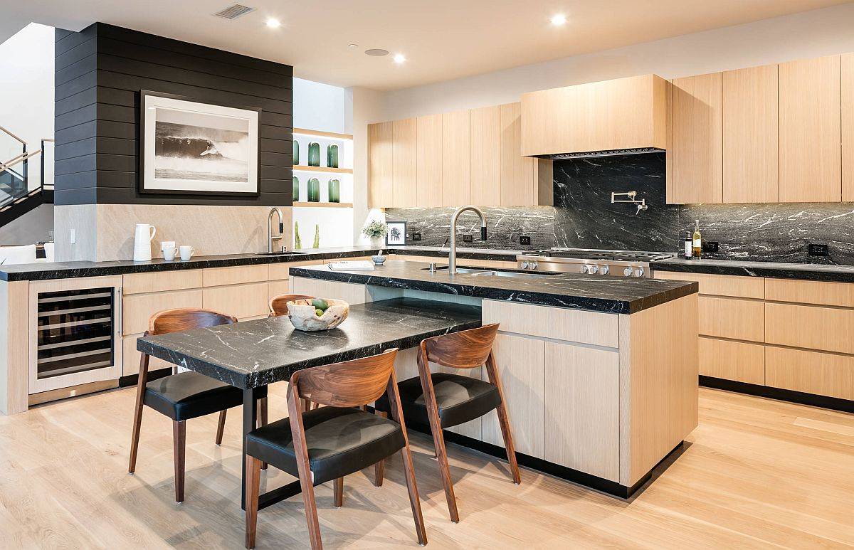 Black marble countertops bring something different to this lovely mdoern kitchen