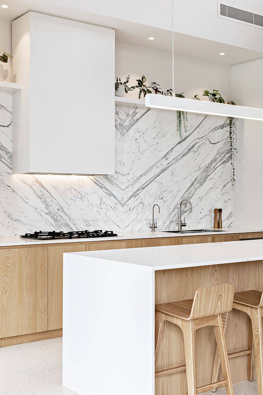 Custom minimal hood and range for the sleek contemporary kitchen in white and wood
