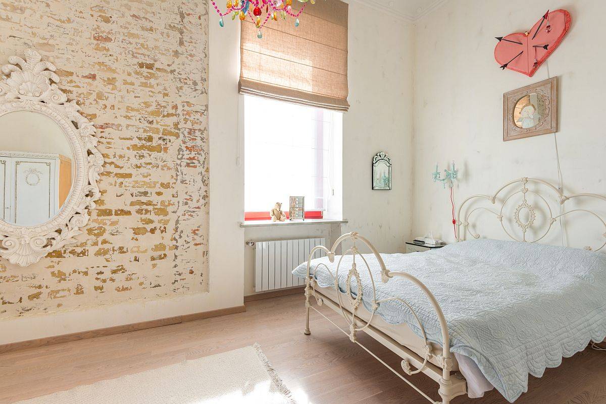 Exposed brick wall section for the modern eclectic bedroom in white