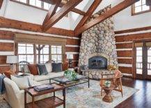 Eye-catching-stone-fireplace-in-the-corner-makes-the-biggest-impact-in-this-double-height-transitional-living-room-50670-217x155