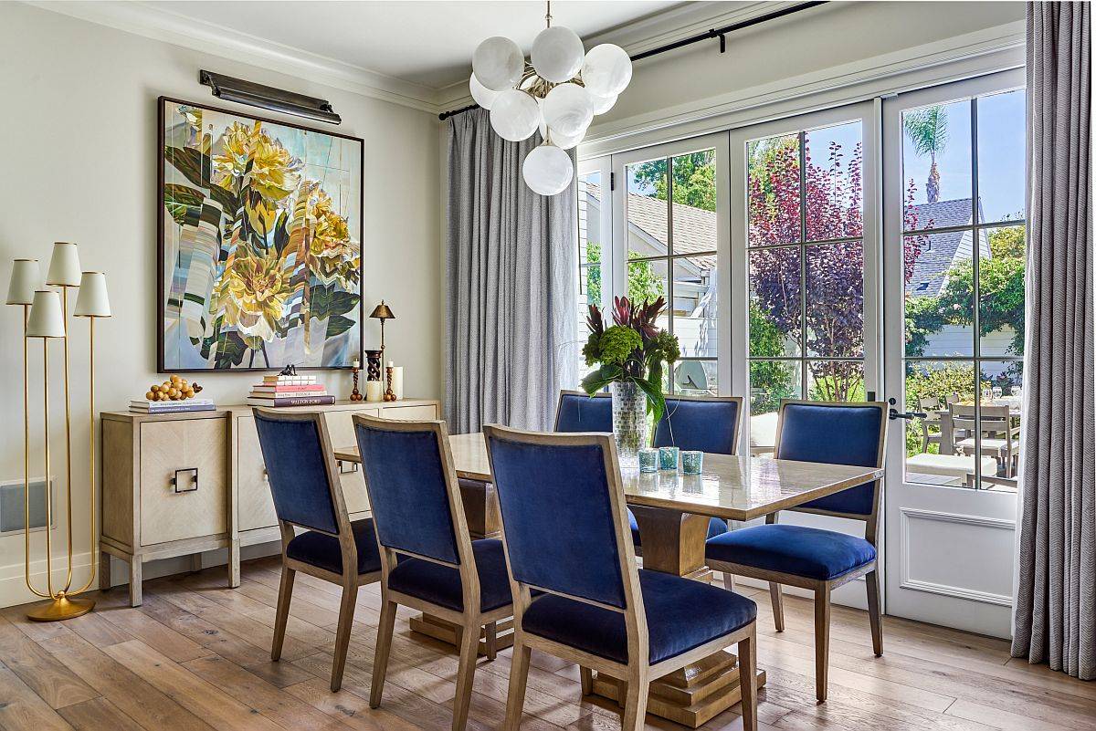 Flowery wall art additions brings pops of yellow to this light-filled dining space
