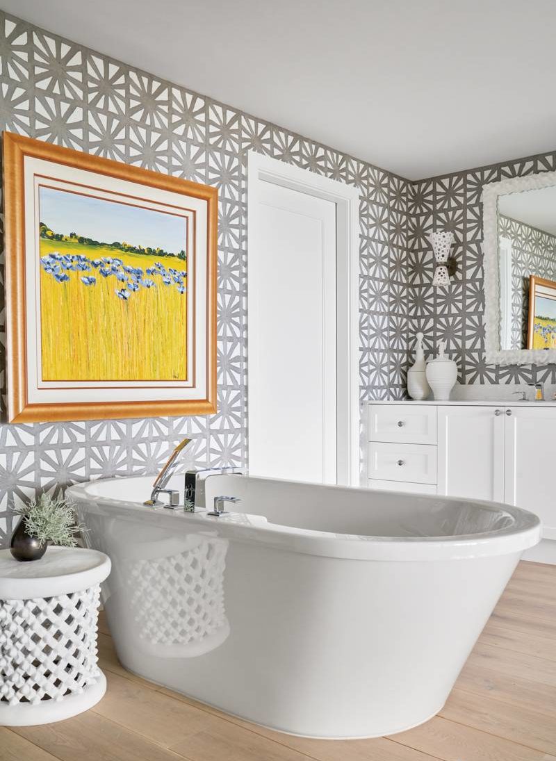 white bathtub with painting as window privacy cover