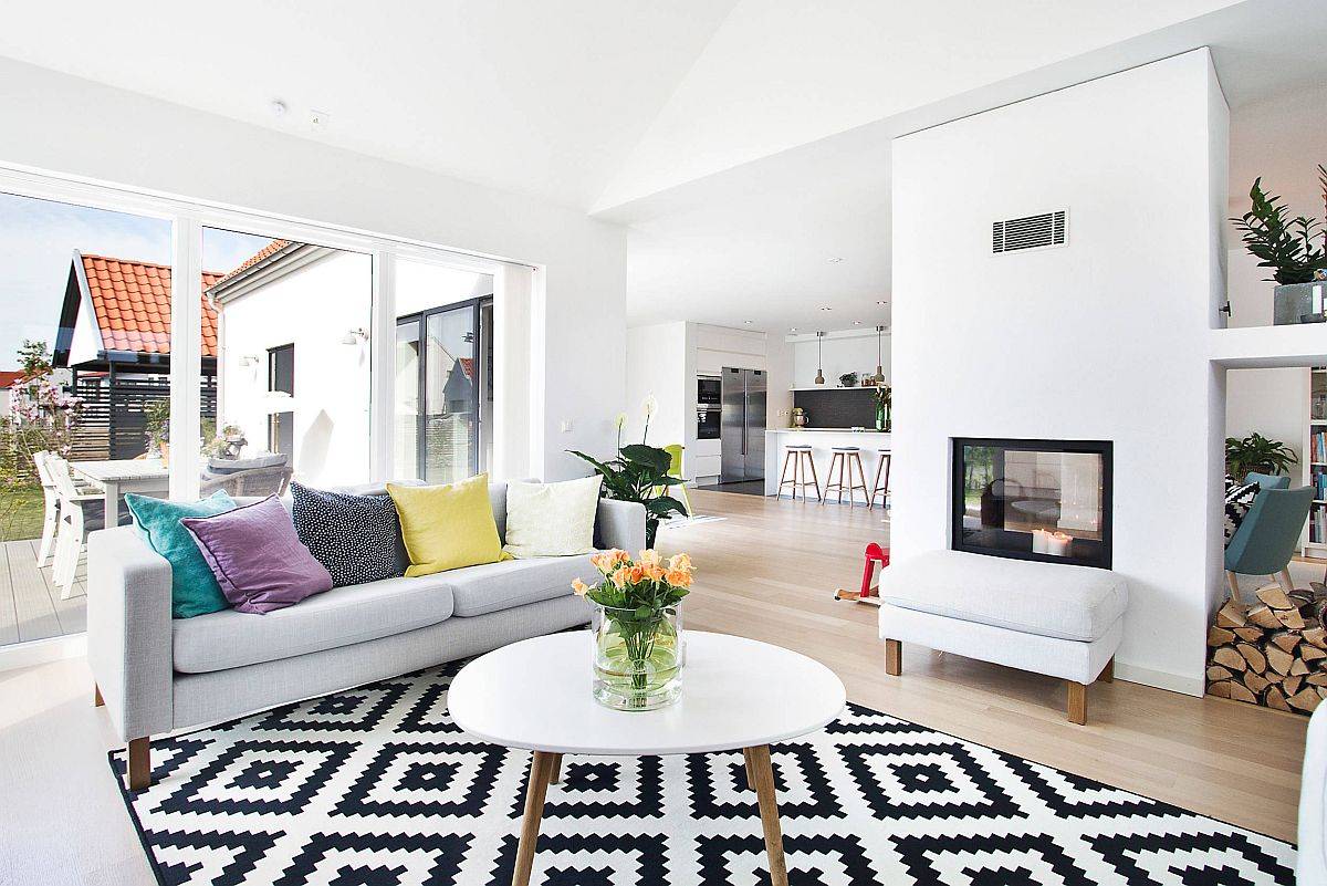 Lovely open-plan living area in white with modern scandinavian style and a striking area rug