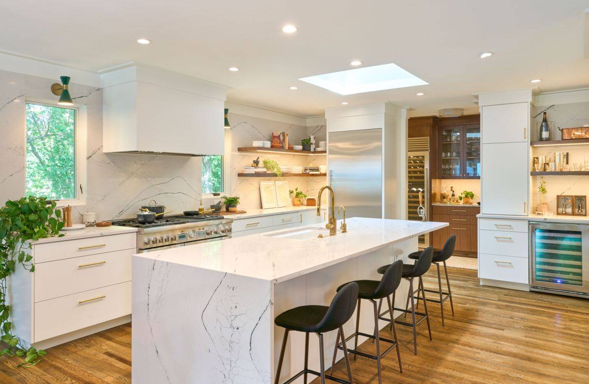 Lovely white quartz countertops and backsplash for the curated modern kitchen