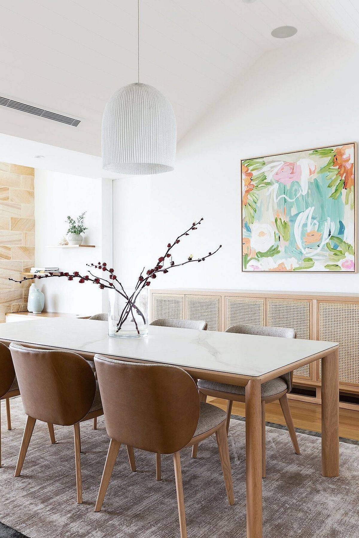 Multi-colored wall art piece is perfect for the breezy beach style dining space