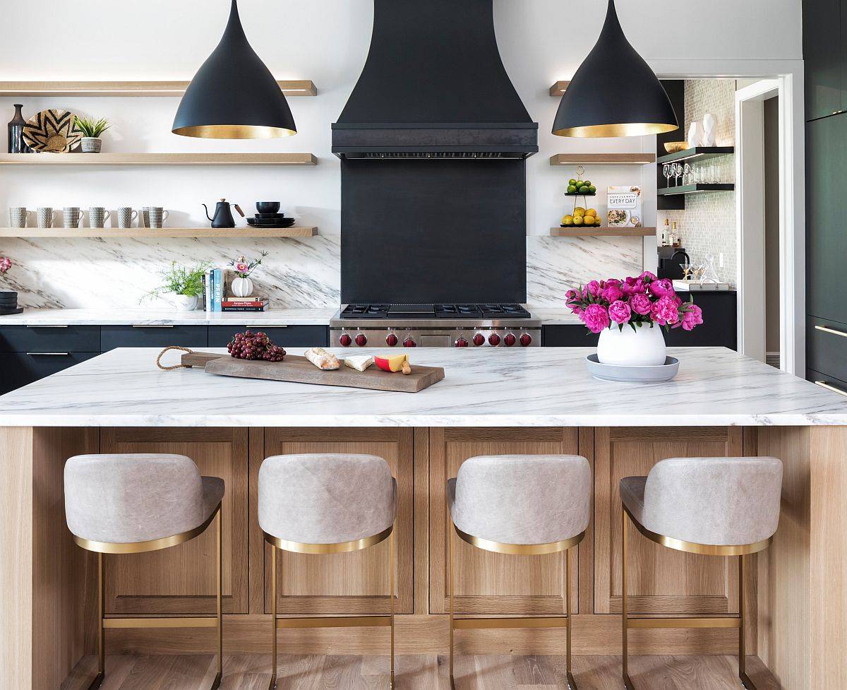 Penadnts add contrast and elegance to the polished kitchen with marble countertops