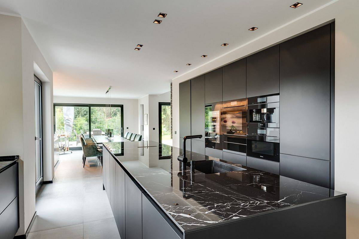 Polished engineered quartz in black is perfect for this minimal kitchen