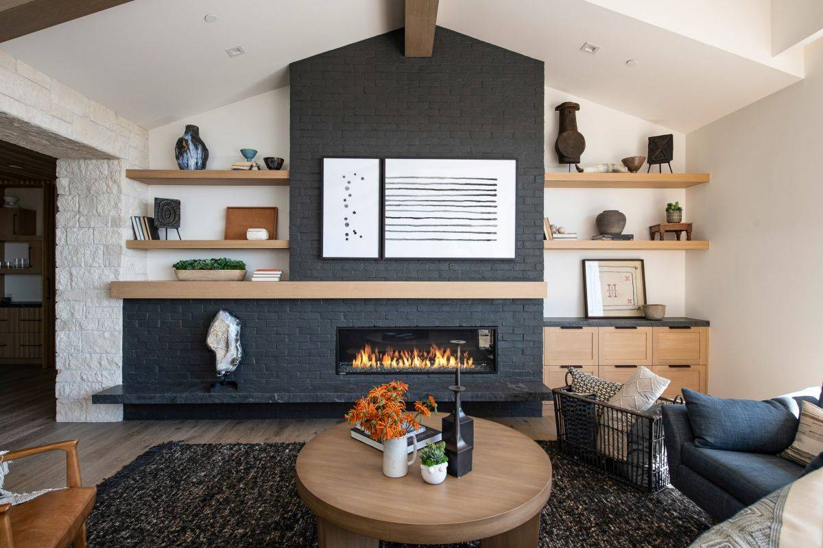 Sophisticated contemporary beach style living space with a striking fireplace area