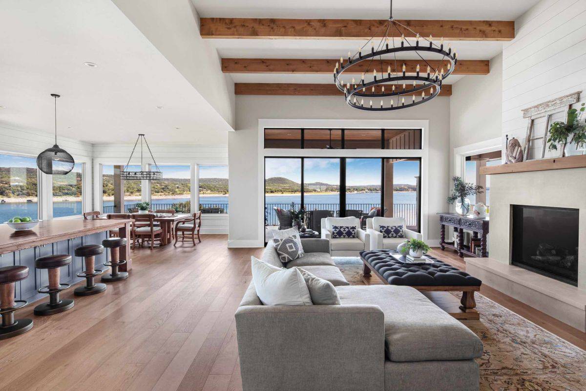 Spacious open-plan living area with a fiteplace and lovely water views
