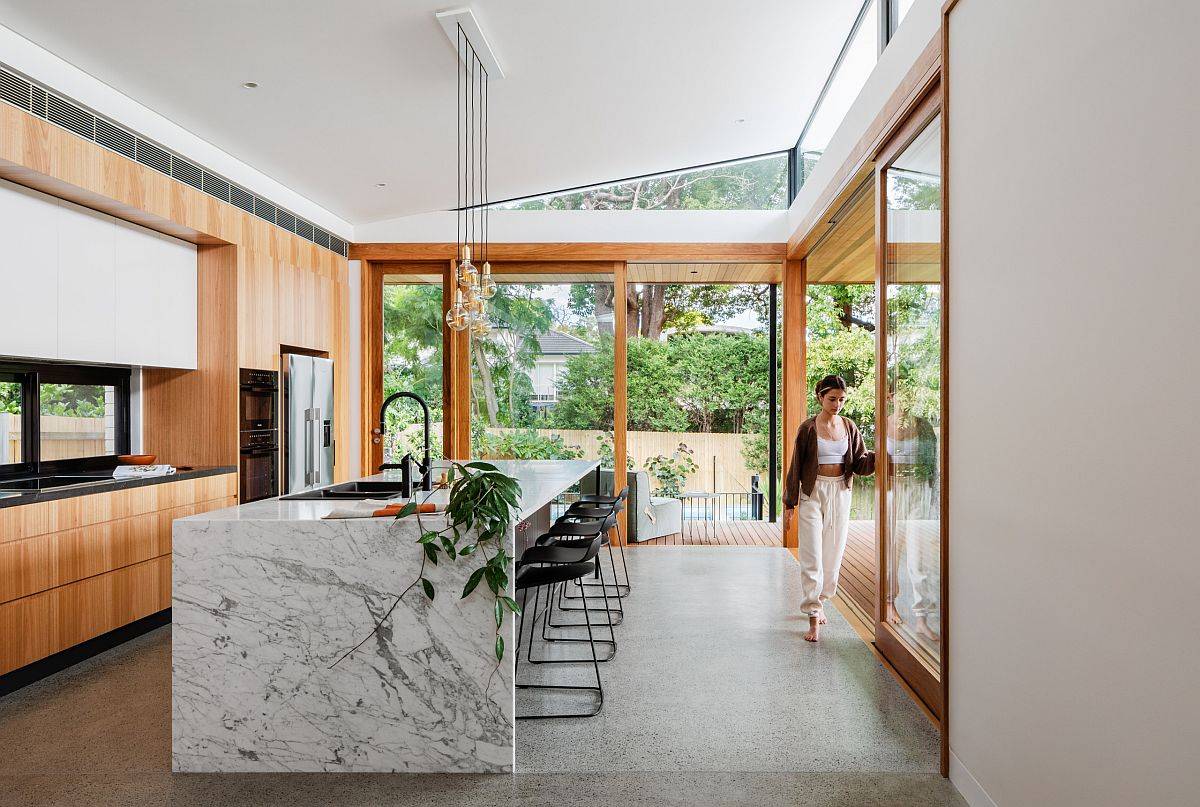 Stunning marble kitchen island is the biggest attraction in this modern kitchen
