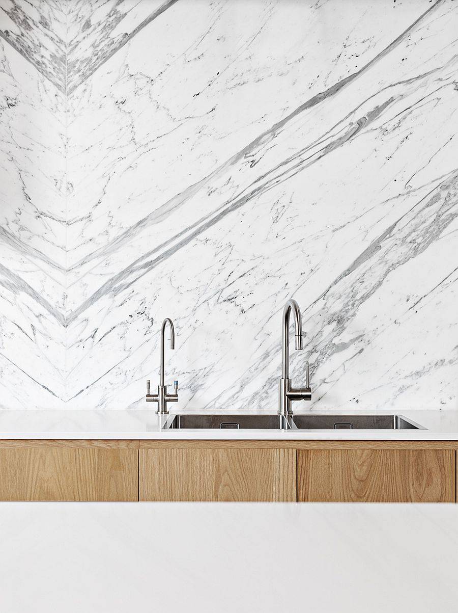 Take a closer look at the marble backsplash of the kitchen along with sparkling faucets