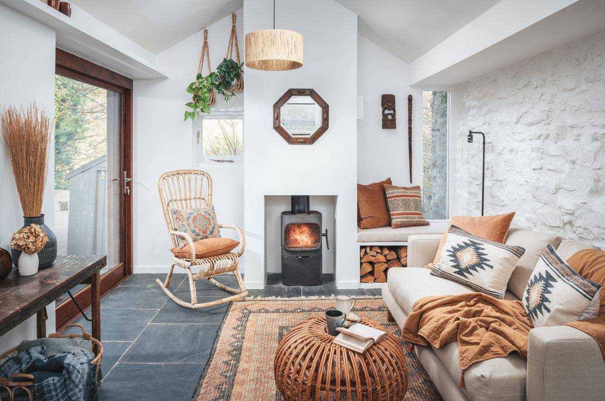 Textured walls coupled with fireplace and comfy couch in the small living space