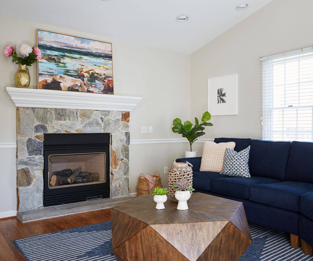 Wall art above the fireplace adds even more color to this beach style living room