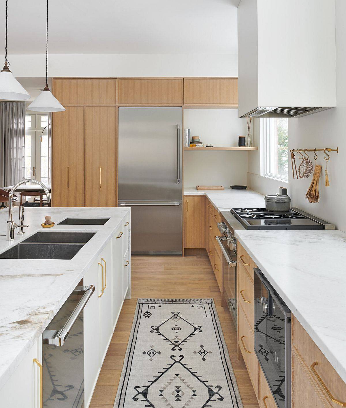 White marble countertops complement the wood cabinets beautifully in this kitchen