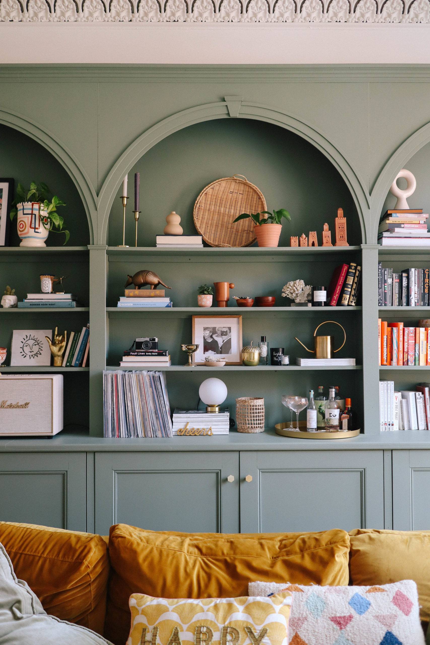 Arched built-in bookshelf in lovely sage tone