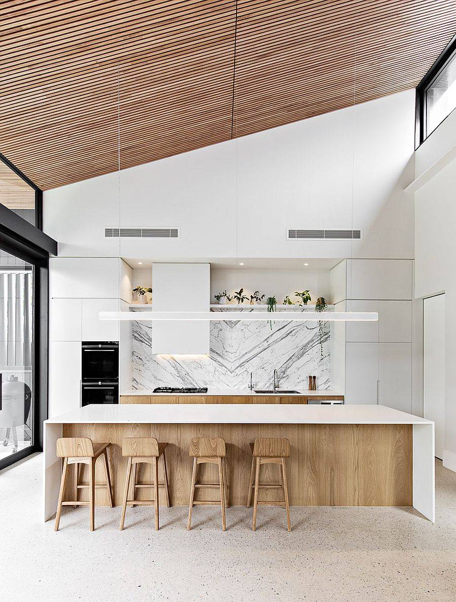 sloped ceiling in wood along with sliding glass doors for the kitchen in wood and white