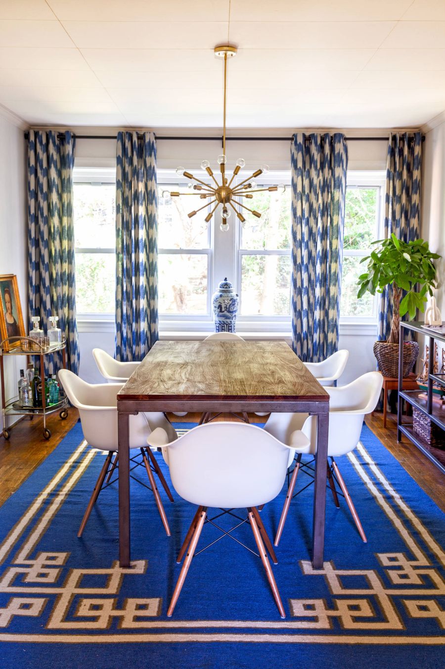 Carpet and drapes add additional pops of blue to the dining room