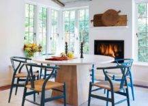Classic-wishbone-chair-in-blue-adds-color-and-class-to-this-white-dining-room-with-fireplace-50287-217x155