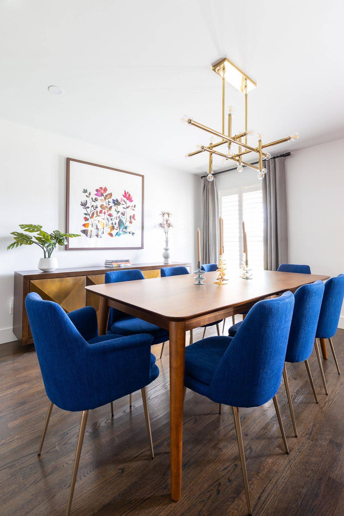 Comfortable dining table chairs bring blue to this modern white dining room