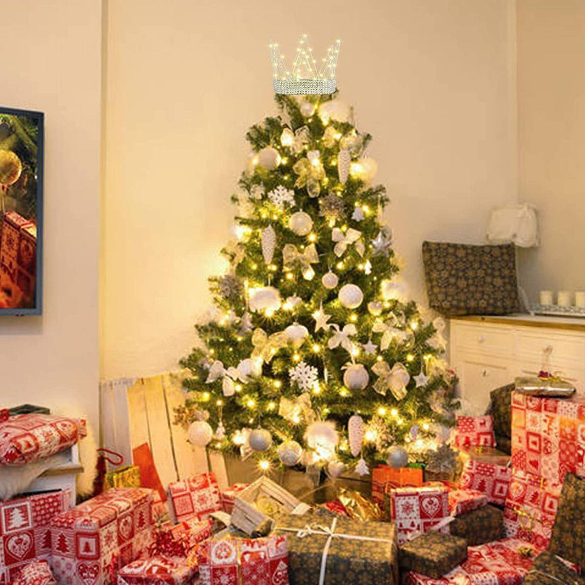 Decorating the Christmas tree with the Crown tree topper