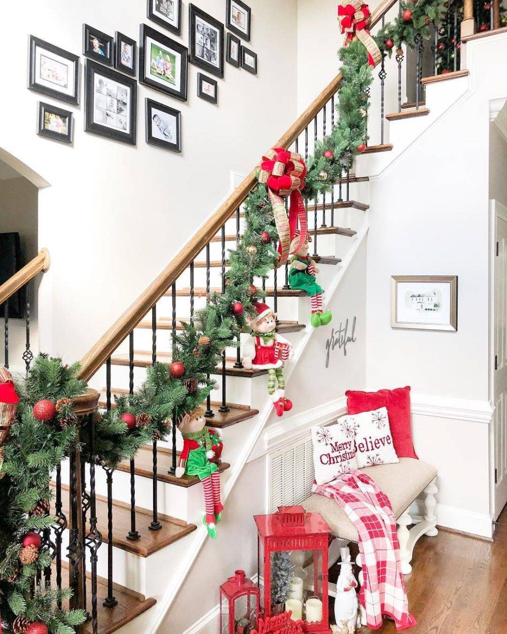 Fun way to decorate the entry with stairs using a Christmas garland and some elves