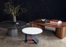 Black vertical wood accent wall, and multiple tables in various shapes.