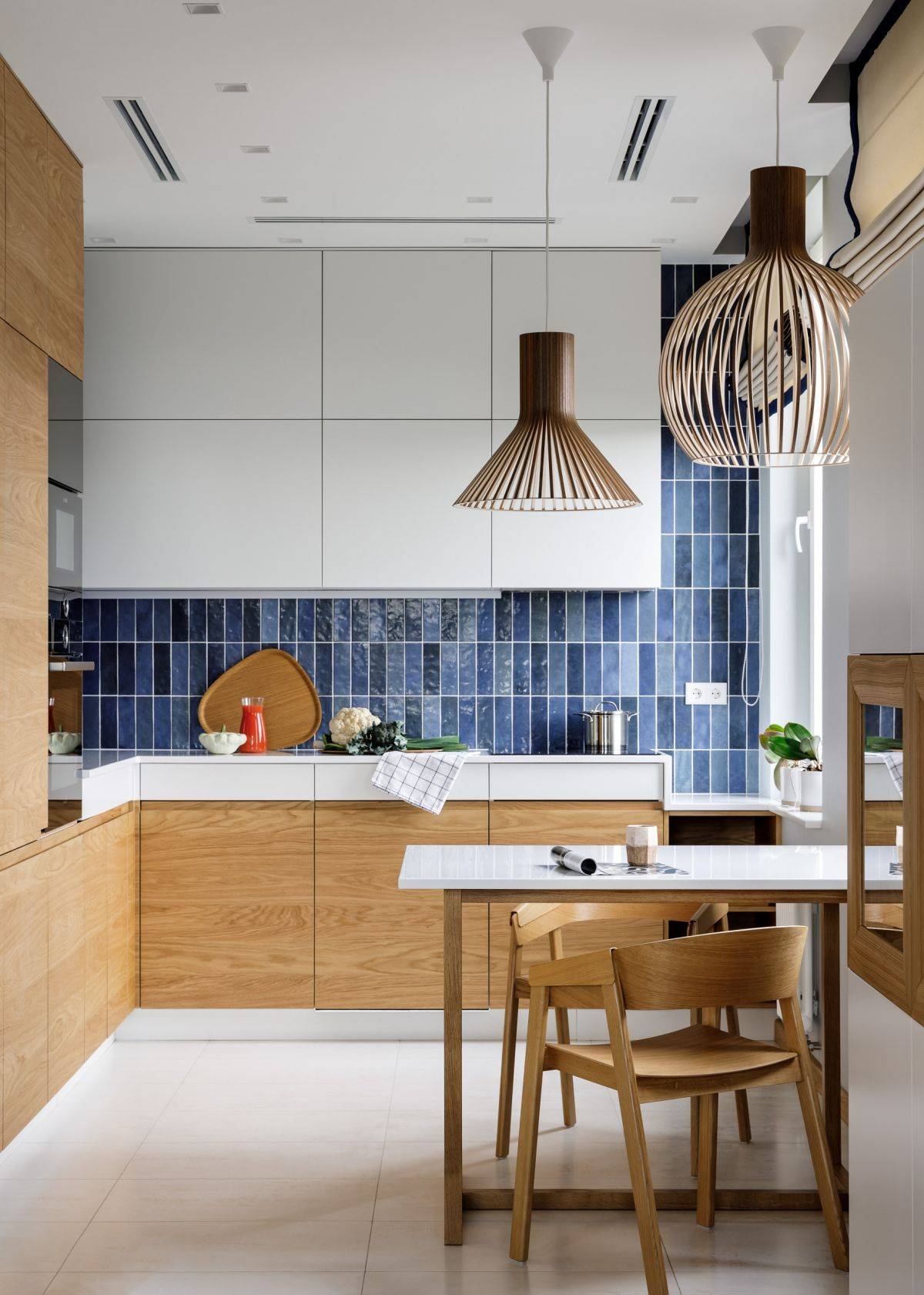 Backsplash with vertical tile pattern in blue is perfect for the trendy modern, neutral kitchen