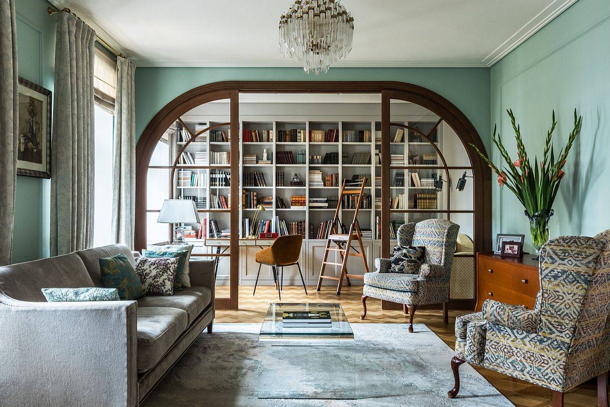 Bookshelf steals the spotlight in this beautiful green living room