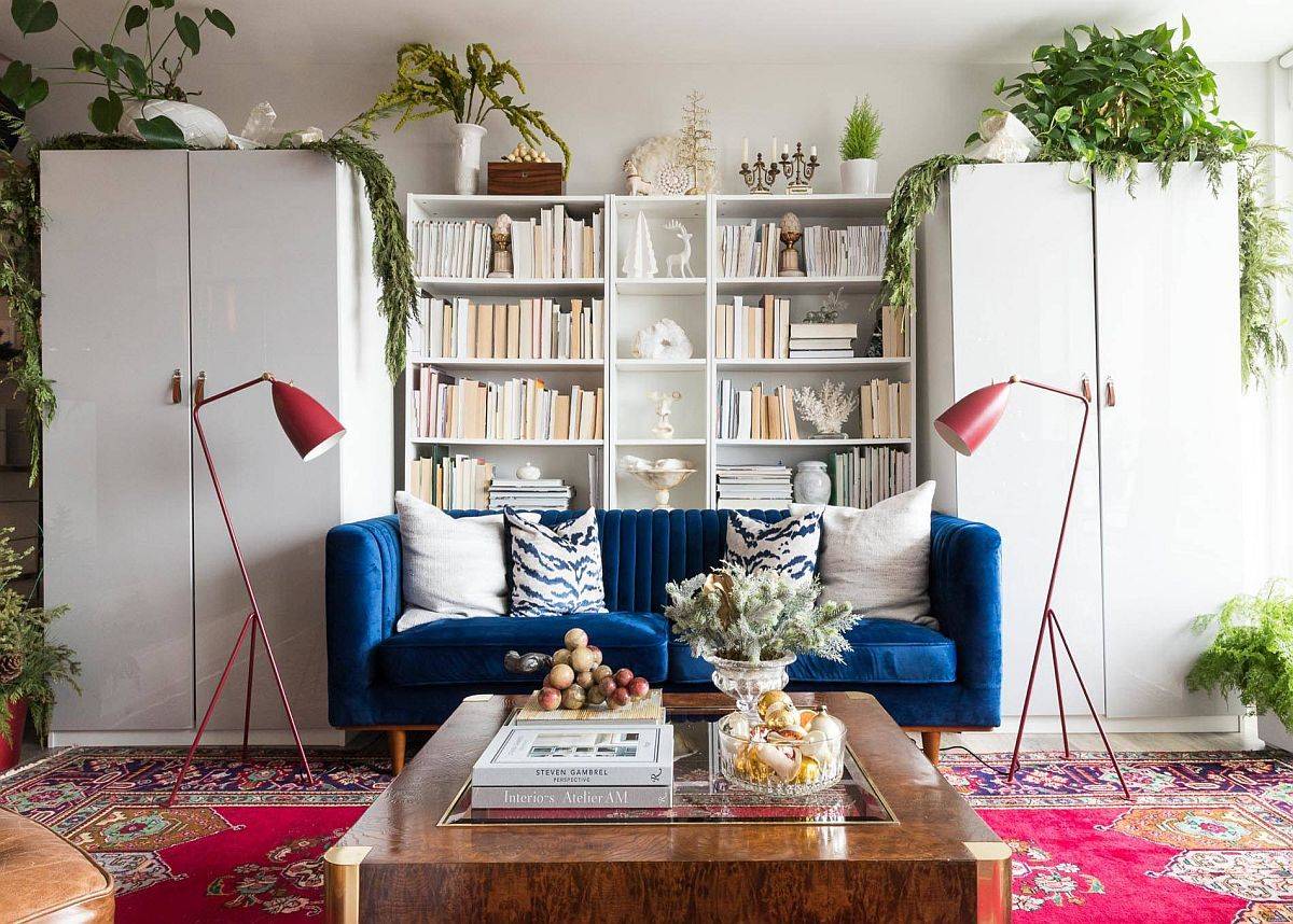 Brilliant chouch in blue adds vivacious charm to this greenery filled living room