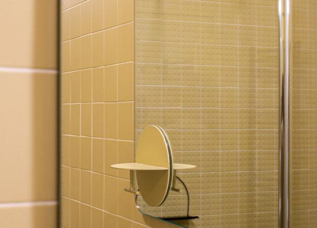 Closer-look-at-the-mirror-and-vanity-inside-the-modern-bathroom-in-light-yellow-66917-217x155