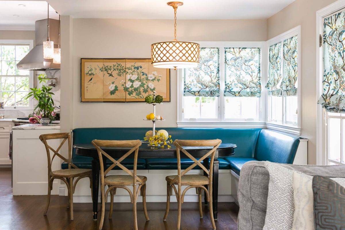 Colorful seating of the banquette enlivens this traditional kitchen