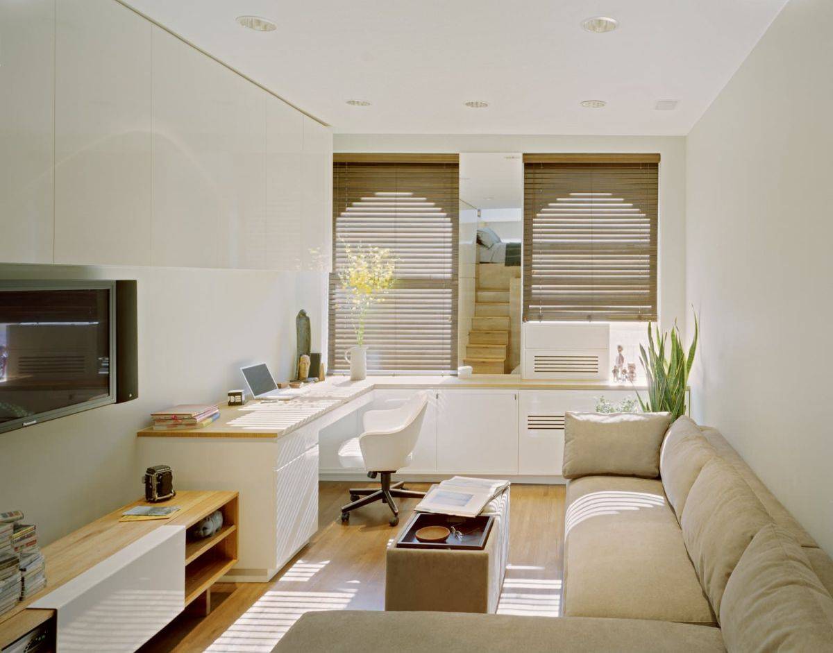 Comfortable scetional and a TV bring relaxation space to this small home office
