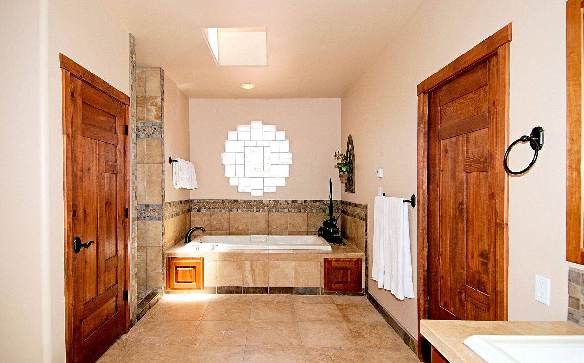 Creative use of glass blocks to bring light into the spacious master bathroom with traditional style